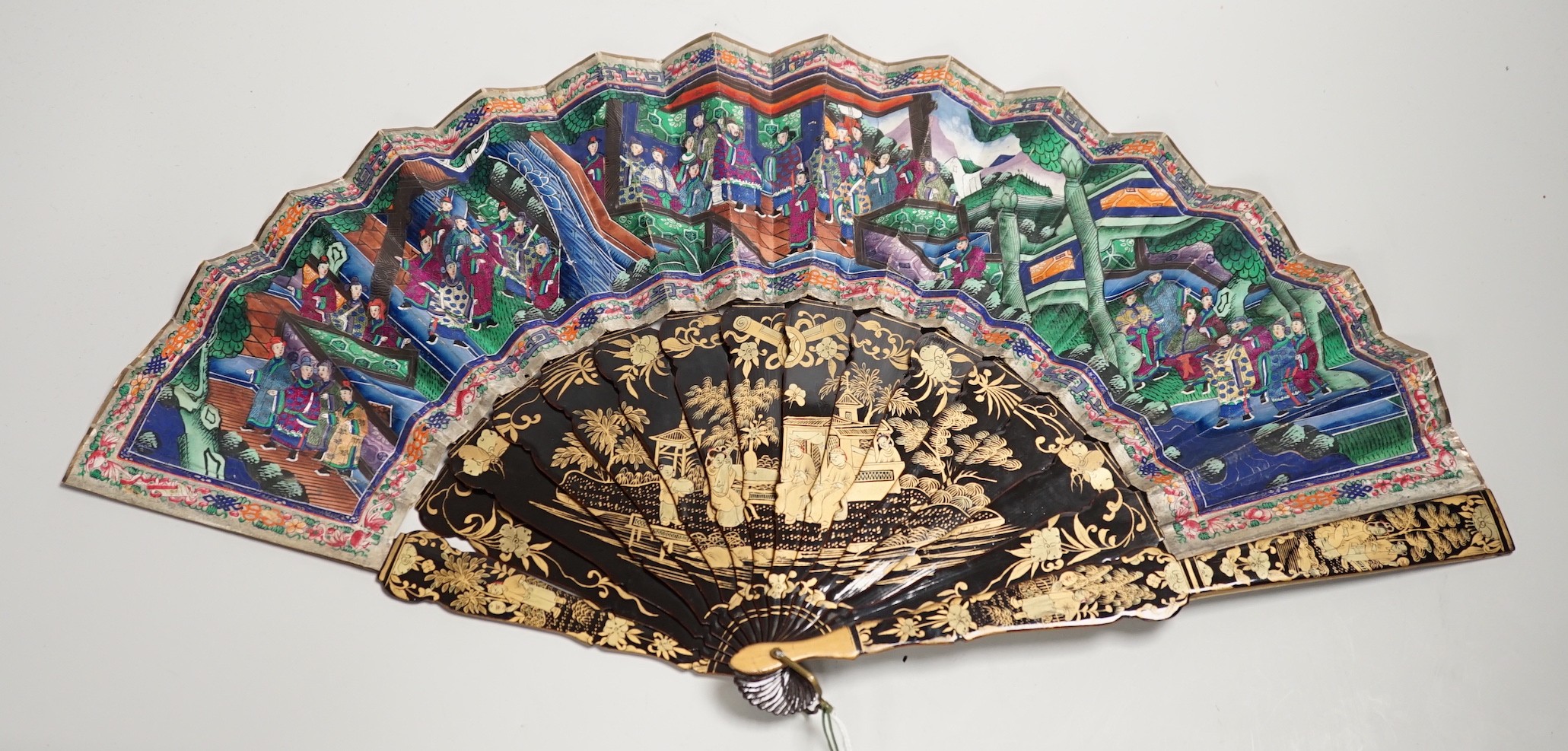 A 19th century Chinese painted paper leaf and lacquer painted fan in a gilt decorated black lacquer fitted case, the fan with painted ivory appliqué faces, 28cm